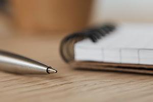 Header image of a notebook and pen