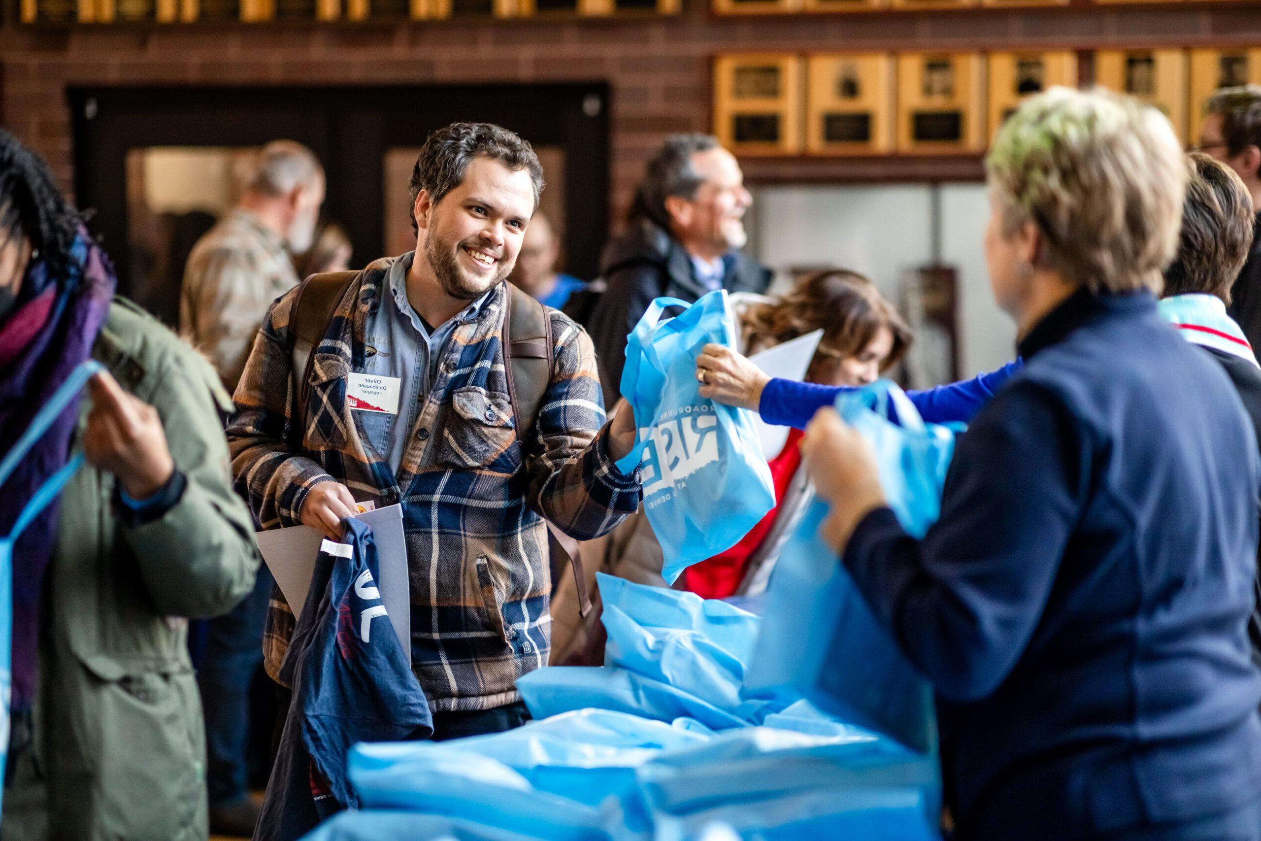 Guests receiving free gifts at Roadrunners Rise Campaign Launch event